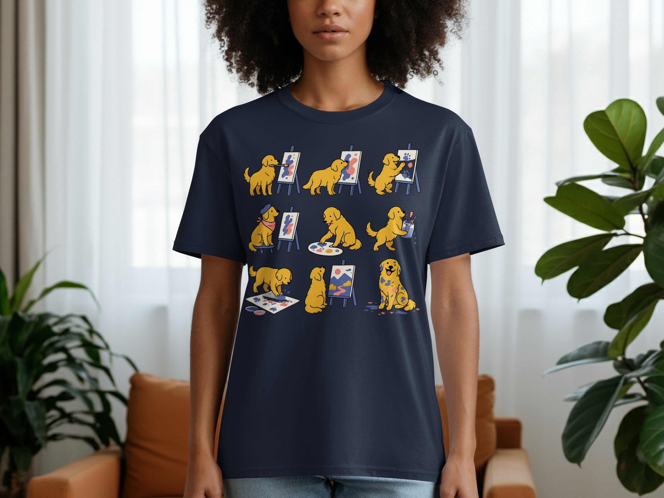 Dark blue t-shirt with a graphic of golden retrievers painting with paw prints and brushes.