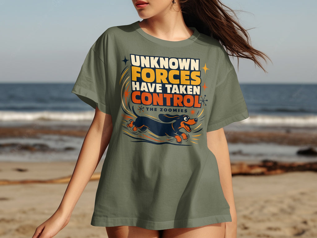 Olive t-shirt with dachshund running and text "Unknown Forces Have Taken Control The Zoomies."