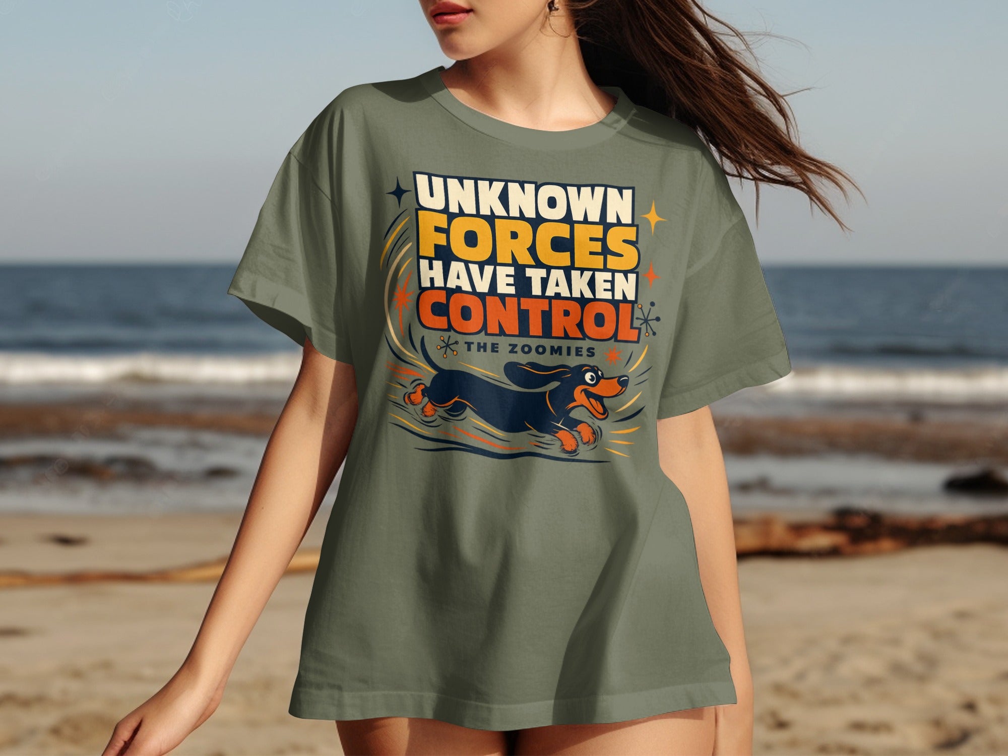 Olive t-shirt with dachshund running and text "Unknown Forces Have Taken Control The Zoomies."