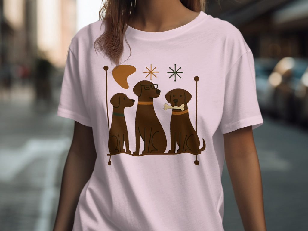 Illustration of three brown dogs with a bone, glasses, and festive stars on a t-shirt.