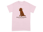 Brown dog sitting on pink t-shirt with text "Selective Hearing Since Puppyhood."