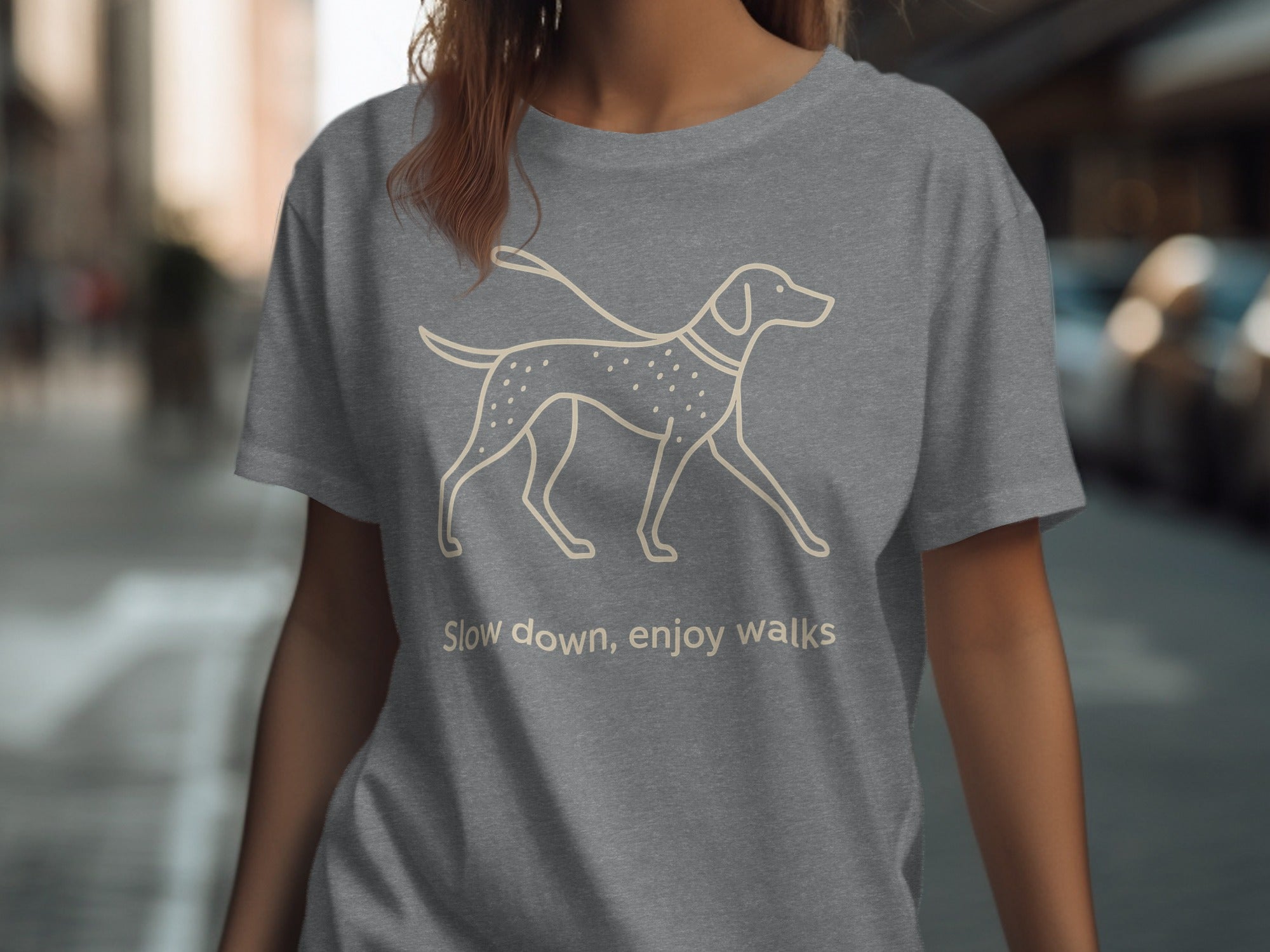 Grey t-shirt with outline of a dog on leash and text "Slow down, enjoy walks".