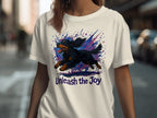 White t-shirt with watercolor dog graphic and "Unleash the Joy" text.