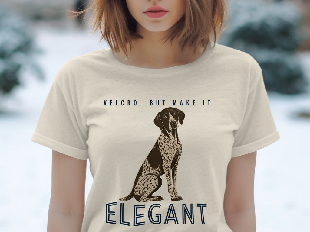Beige t-shirt with a dog illustration and text "Velcro, But Make It Elegant".