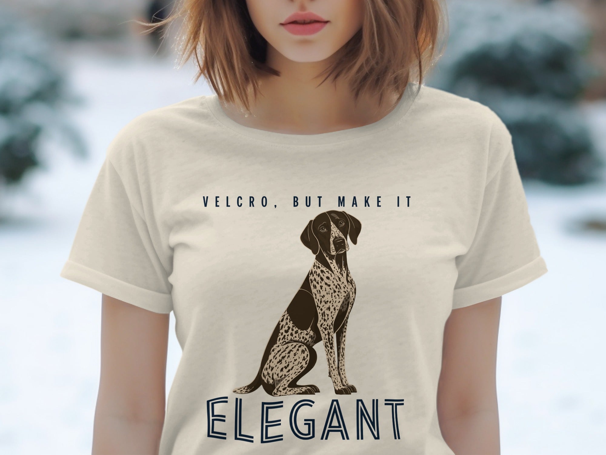 Beige t-shirt with a dog illustration and text "Velcro, But Make It Elegant".