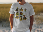 T-shirt print featuring nine black labrador dogs fishing in various whimsical scenarios.