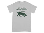 Grey t-shirt with a dark green silhouette of a dog and text "Life update: My lab smelled a thing".