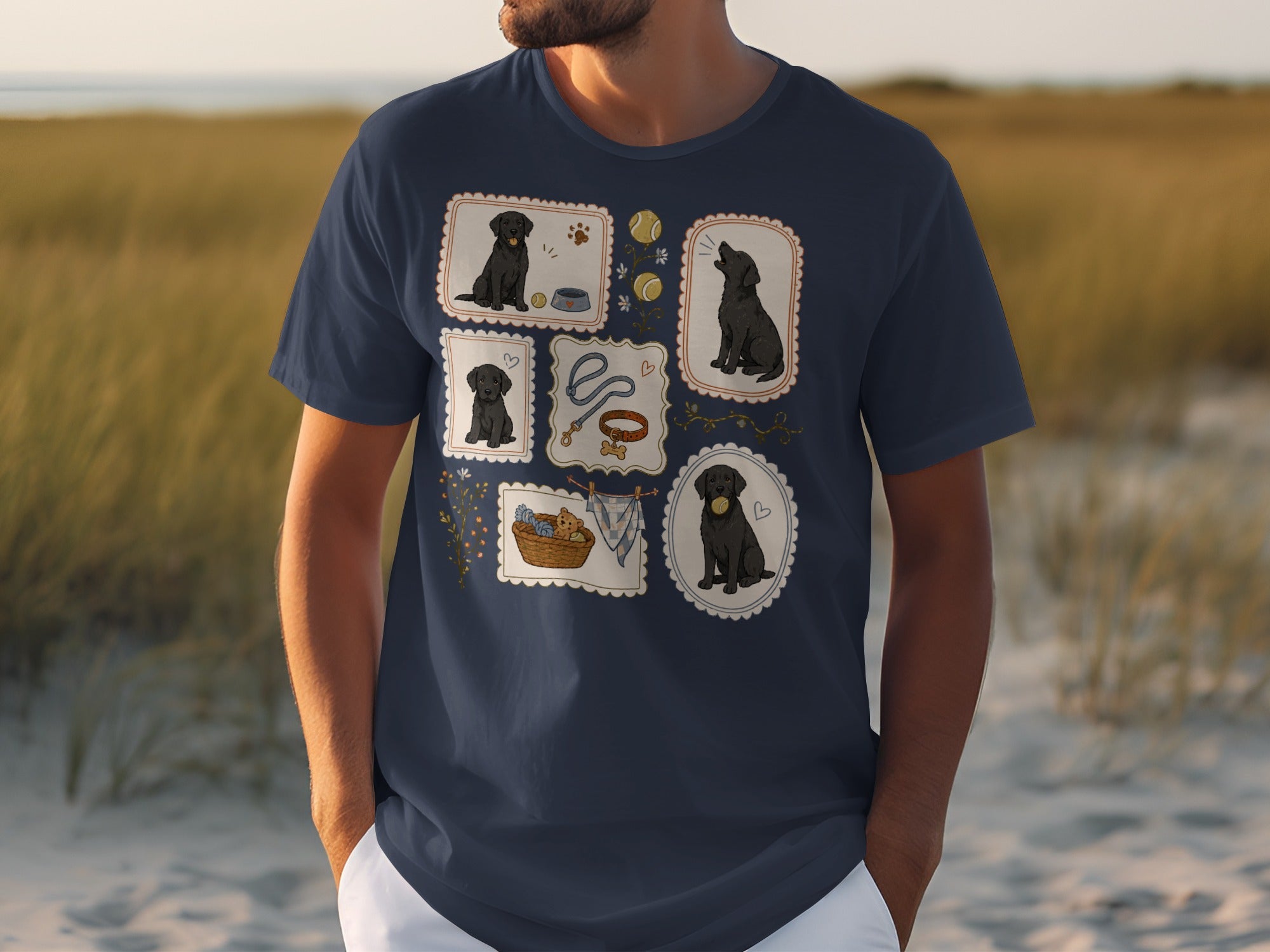 Navy t-shirt with five framed illustrations of black Labrador puppies playing.