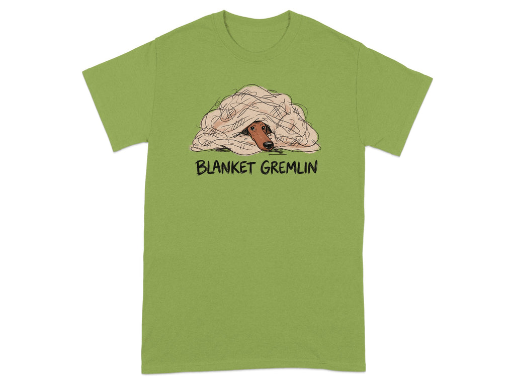 Green t-shirt with a dog peeking out from under a blanket, text "BLANKET GREMLIN".