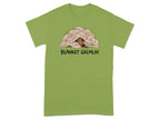 Green t-shirt with a dog peeking out from under a blanket, text "BLANKET GREMLIN".
