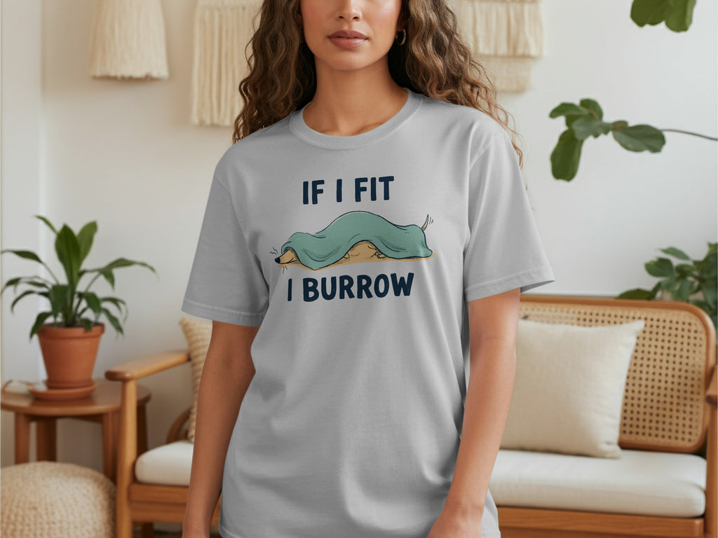 Woman wearing light grey t-shirt with text "IF I FIT I BURROW" and dachshund graphic.