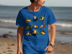 Blue t-shirt with a repeating cartoon pattern of corgis camping and enjoying the outdoors.