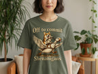 Green t-shirt with a corgi riding a flying goose, text reads "Off to commit Shenanigans".