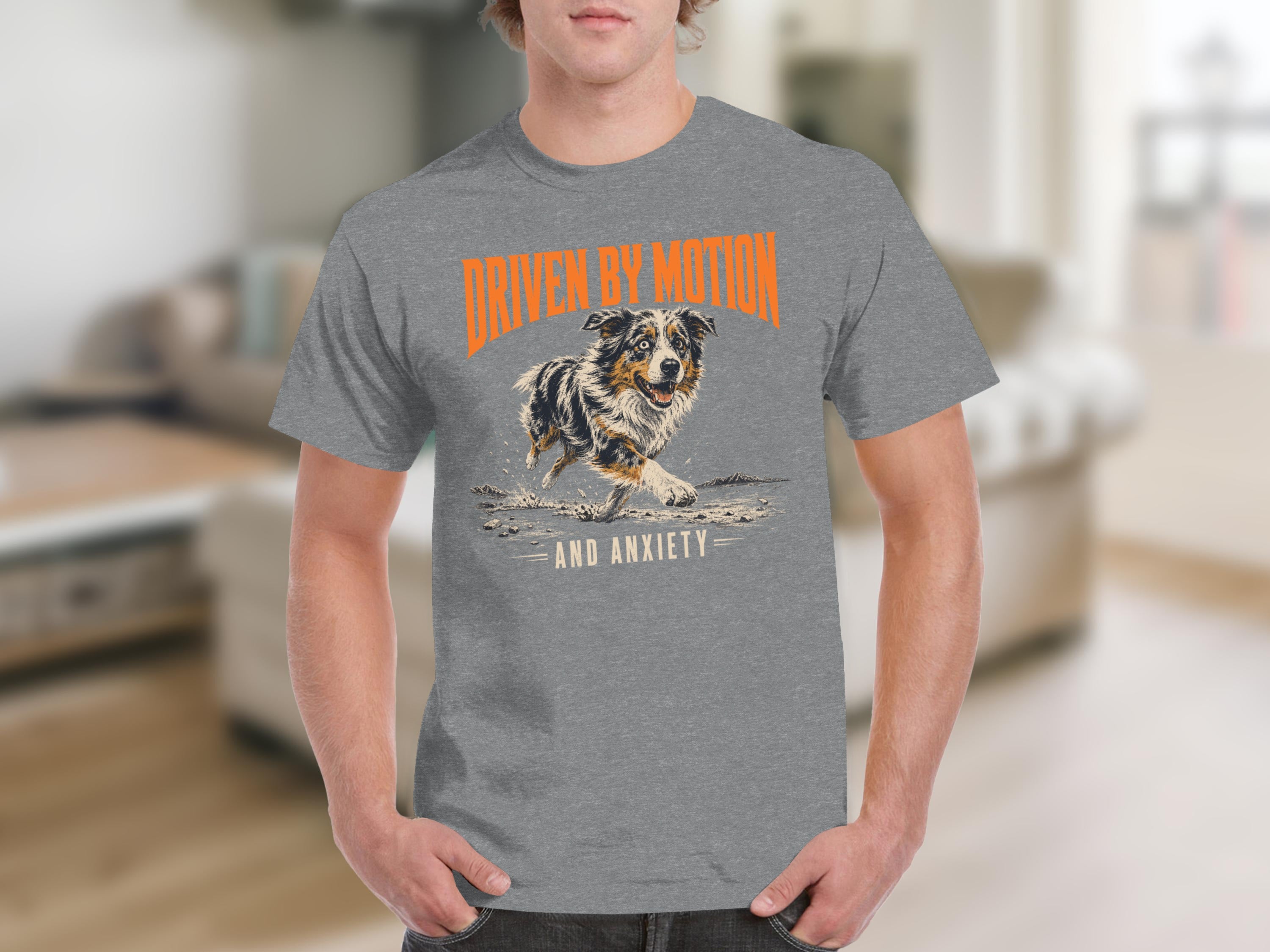 Grey t-shirt with orange text "DRIVEN BY MOTION AND ANXIETY" and an Australian Shepherd.