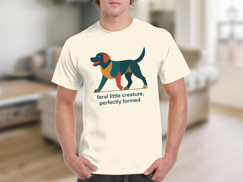 Cream t-shirt with a geometric dog design and text "feral little creature, perfectly formed".