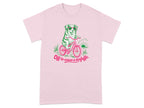 Pink t-shirt with a dog in sunglasses riding a bicycle, "Off to cause a kerfuffle."