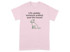 Light pink t-shirt with a cartoon dog and text reading "Life update: someone walked past the house!"