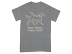 Grey t-shirt with line drawing of a dog on a leash and text "Slow down, enjoy walks."