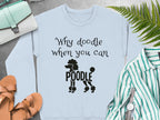 Light blue sweatshirt with "Why doodle when you can POODLE" text and poodle graphic.
