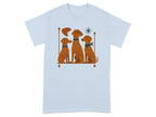 Light blue t-shirt with illustration of three brown dogs sitting on a shelf.