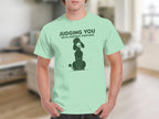 Light green t-shirt with a poodle illustration and the text "JUDGING YOU WITH PERFECT POSTURE".