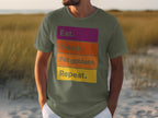 Olive green t-shirt with colorful blocks of text: Eat, Sleep, Pet goldens, Repeat.