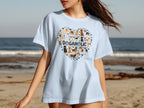 Light blue t-shirt with a heart-shaped dog collage and "DOGAHOLIC" text.