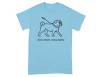 Light blue t-shirt with black line art of a pug on a leash and the text "Slow down, enjoy walks".