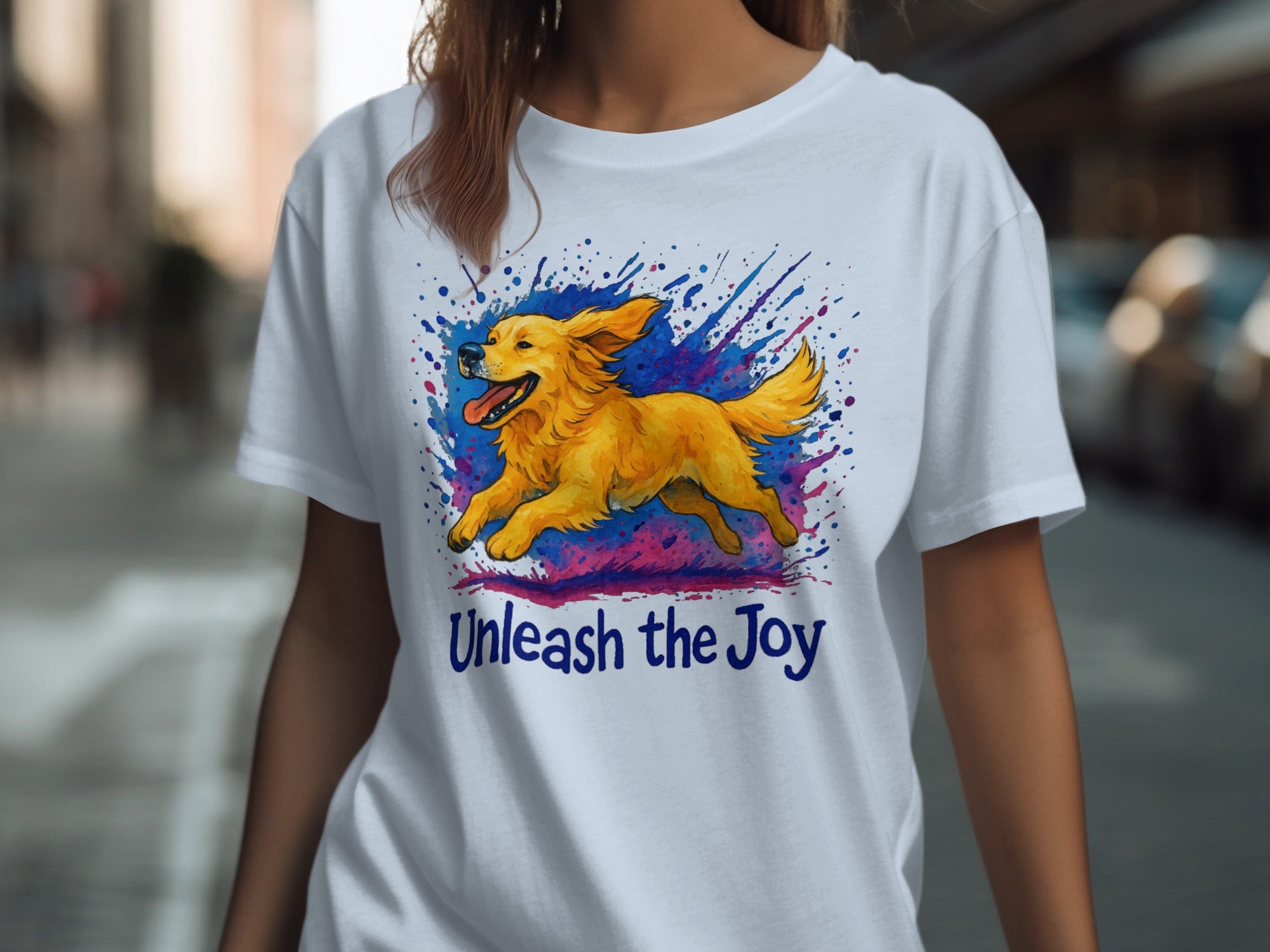 White t-shirt with a running golden retriever graphic and "Unleash the Joy" text.
