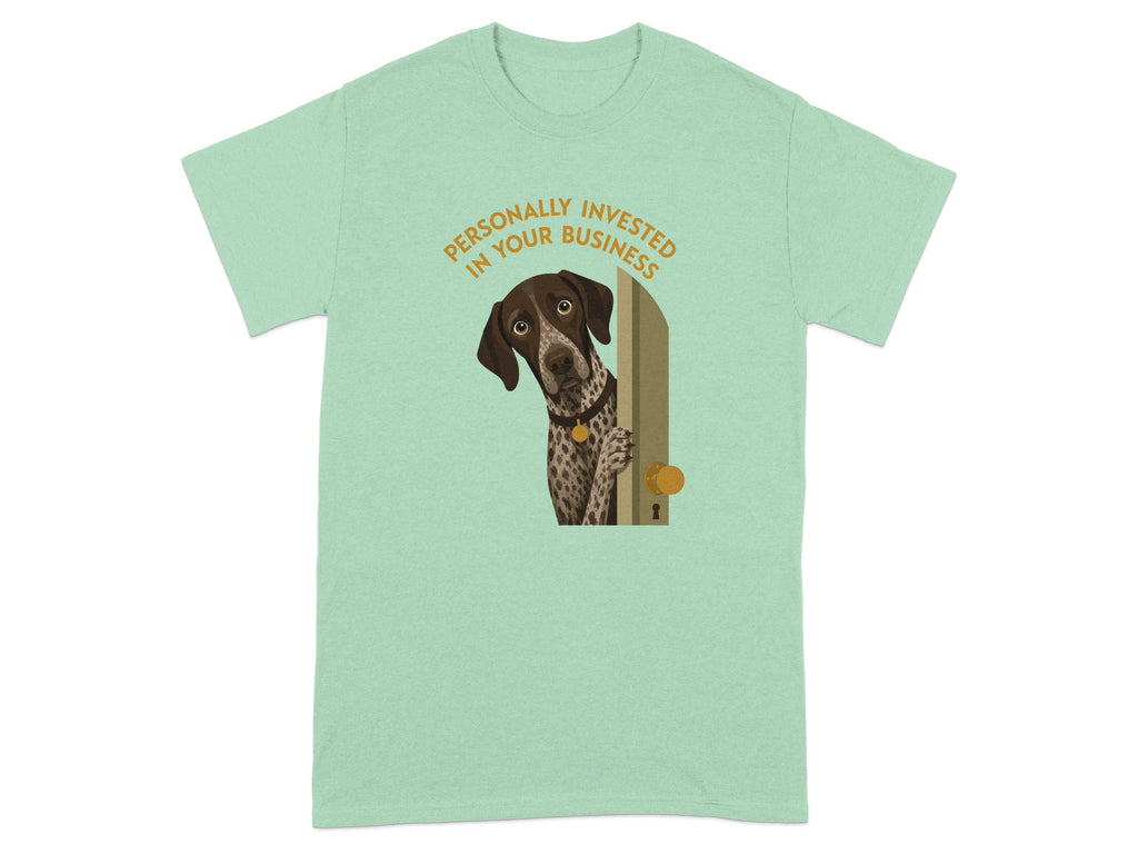 Dog peeking through doorway on a mint green t-shirt.