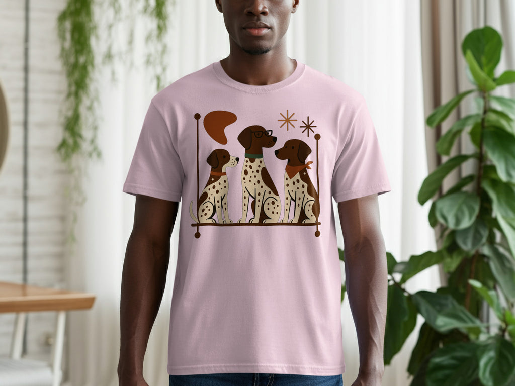 Pink t-shirt with a graphic of three cartoon dogs sitting together.