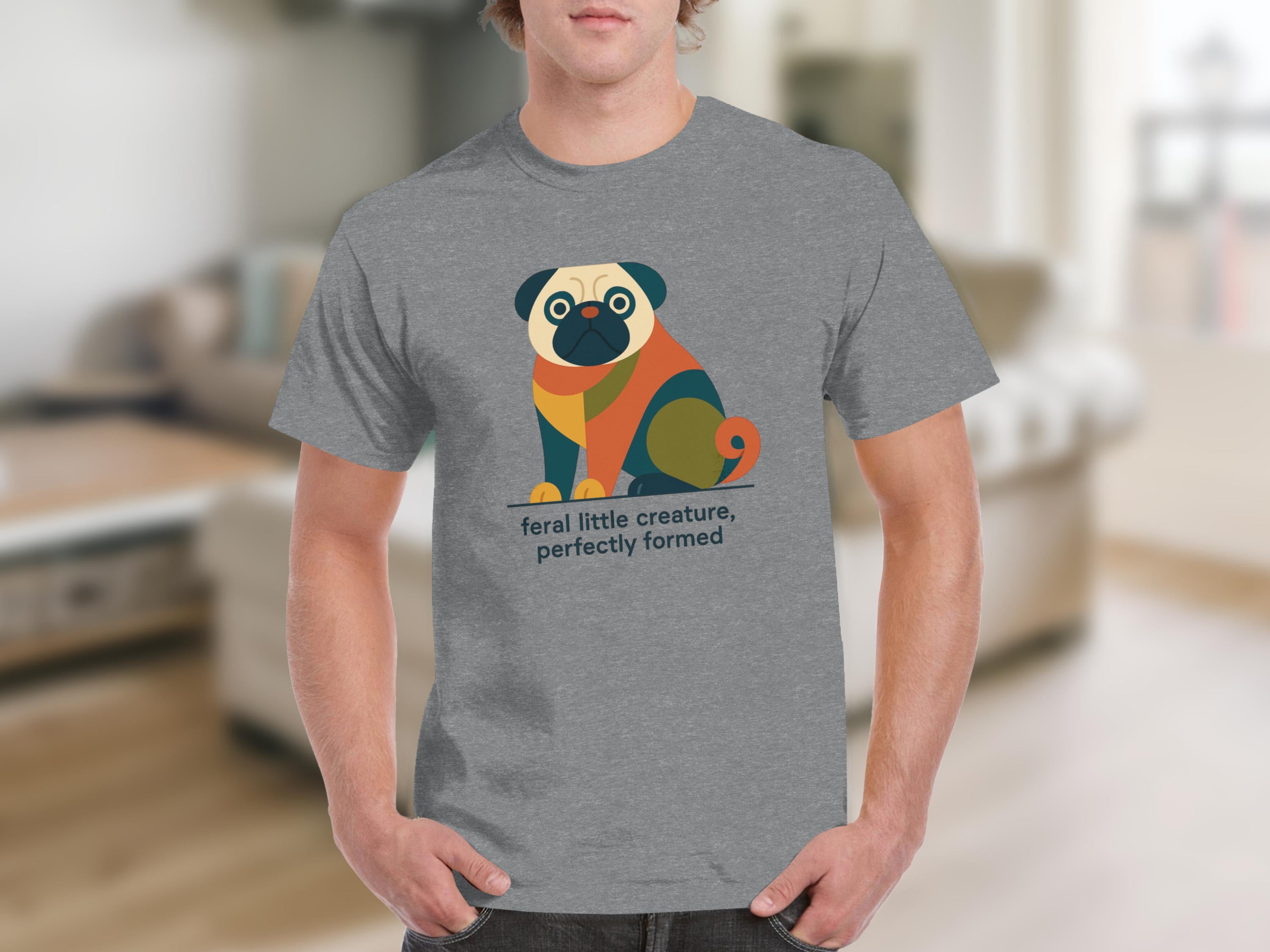 Grey t-shirt with a colorful abstract pug illustration and text "feral little creature, perfectly formed".