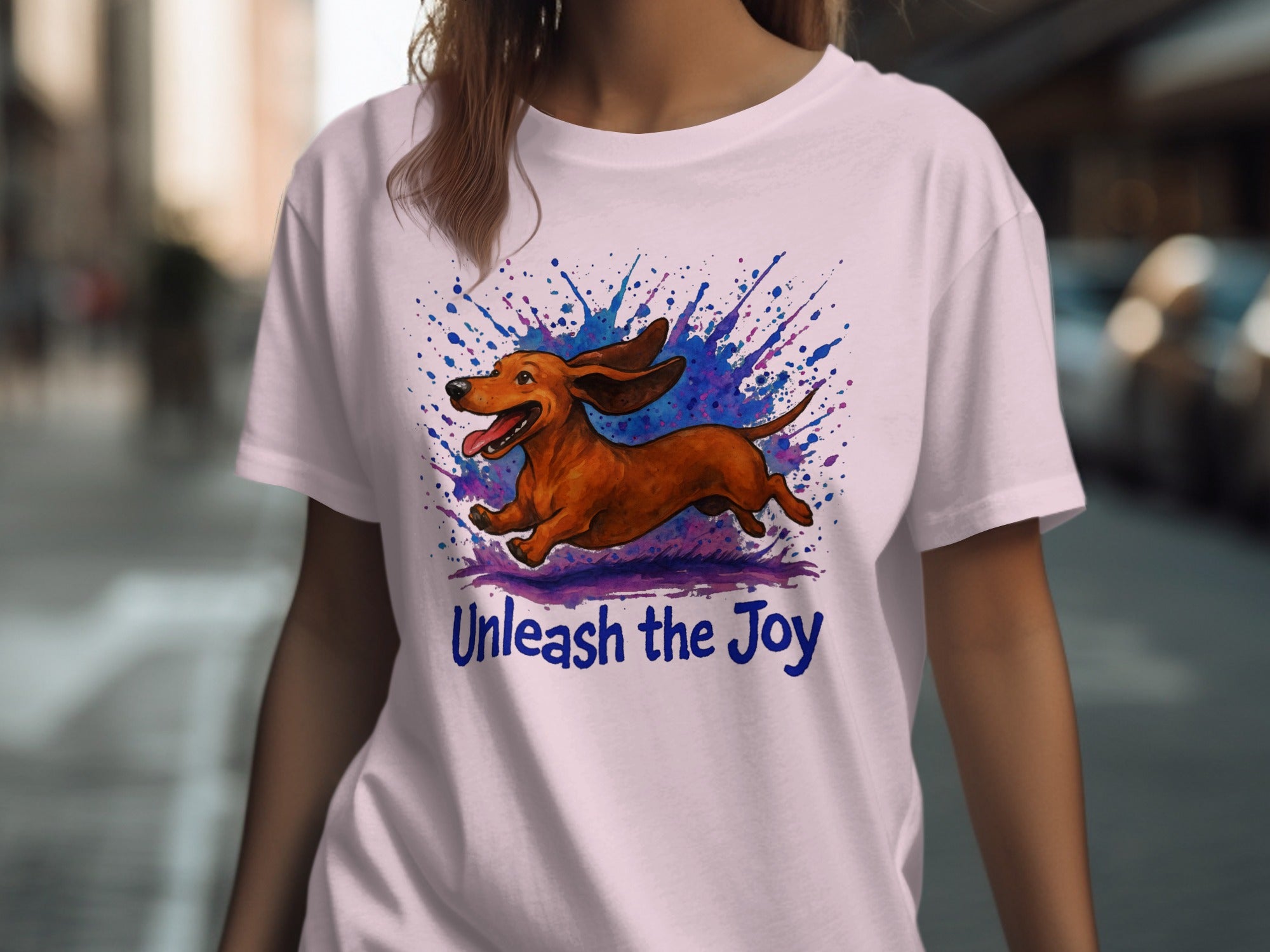 Brown dachshund running with colorful ink splatters and text "Unleash the Joy".