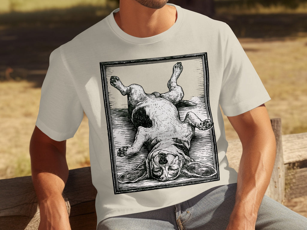 T-shirt featuring a woodcut style illustration of a beagle lying on its back.