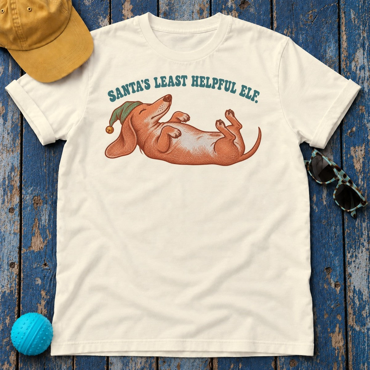 Santa's Least Helpful Elf Dachshund T-Shirt in Natural - flat lay
