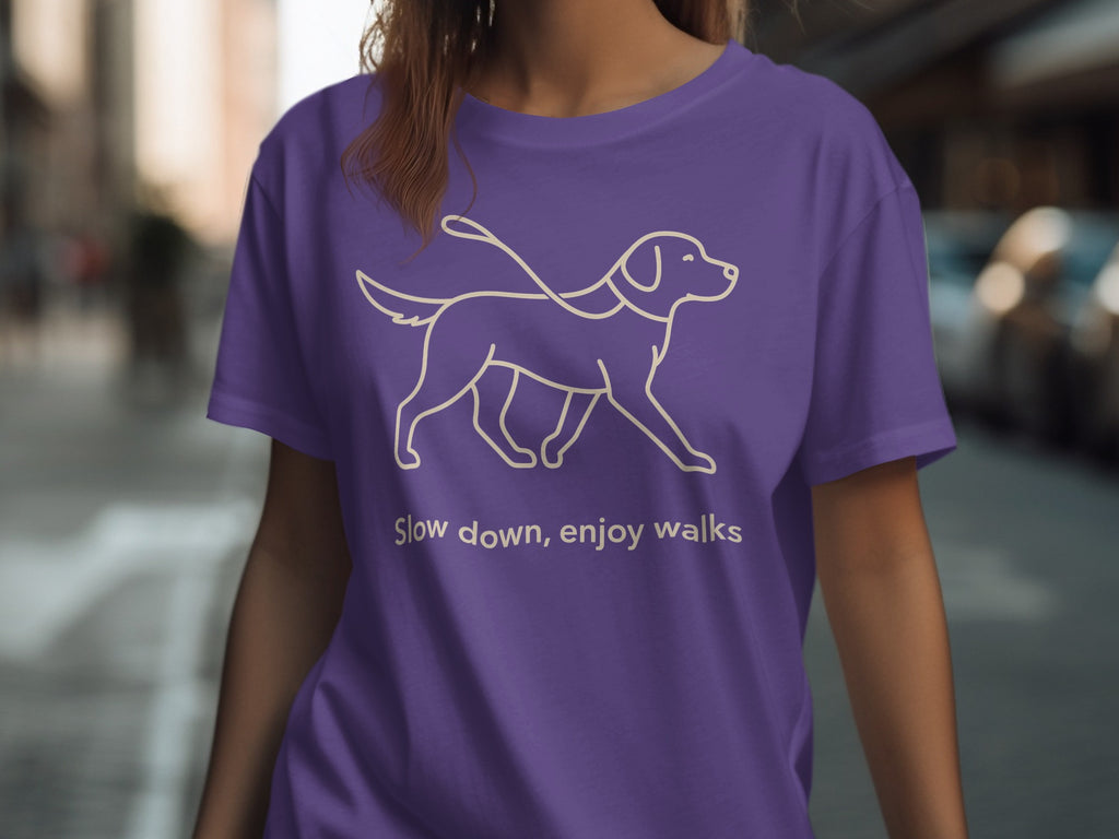 Purple t-shirt with outline of dog on leash and text "Slow down, enjoy walks."