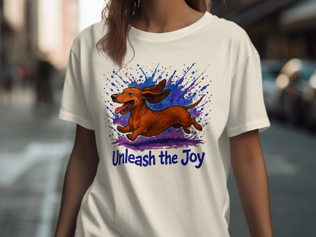 White t-shirt with leaping dachshund and blue purple watercolor splash. Unleash the Joy.