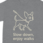 Gray t-shirt with line art of a dog on a leash and text "Slow down, enjoy walks."