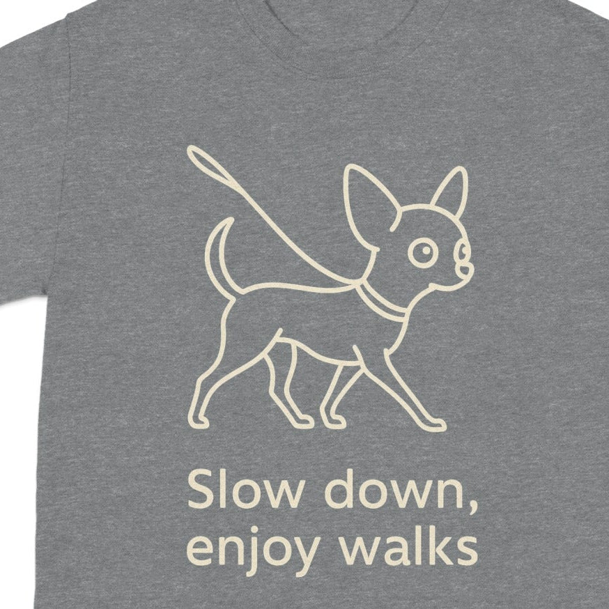 Gray t-shirt with line art of a dog on a leash and text "Slow down, enjoy walks."