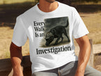 White t-shirt with black text and a black dog wearing a hat.