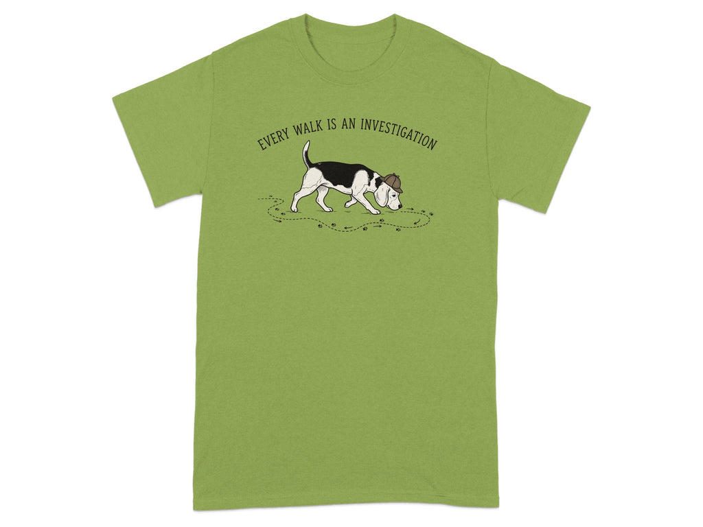 Beagle wearing a detective hat, with paw prints, on a green t-shirt.