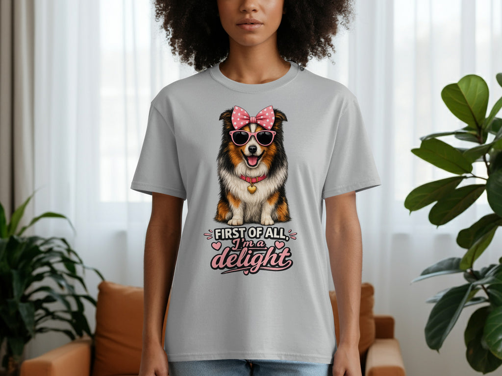 Gray t-shirt with a dog wearing sunglasses and a bow graphic that says "First of all, I'm a delight."