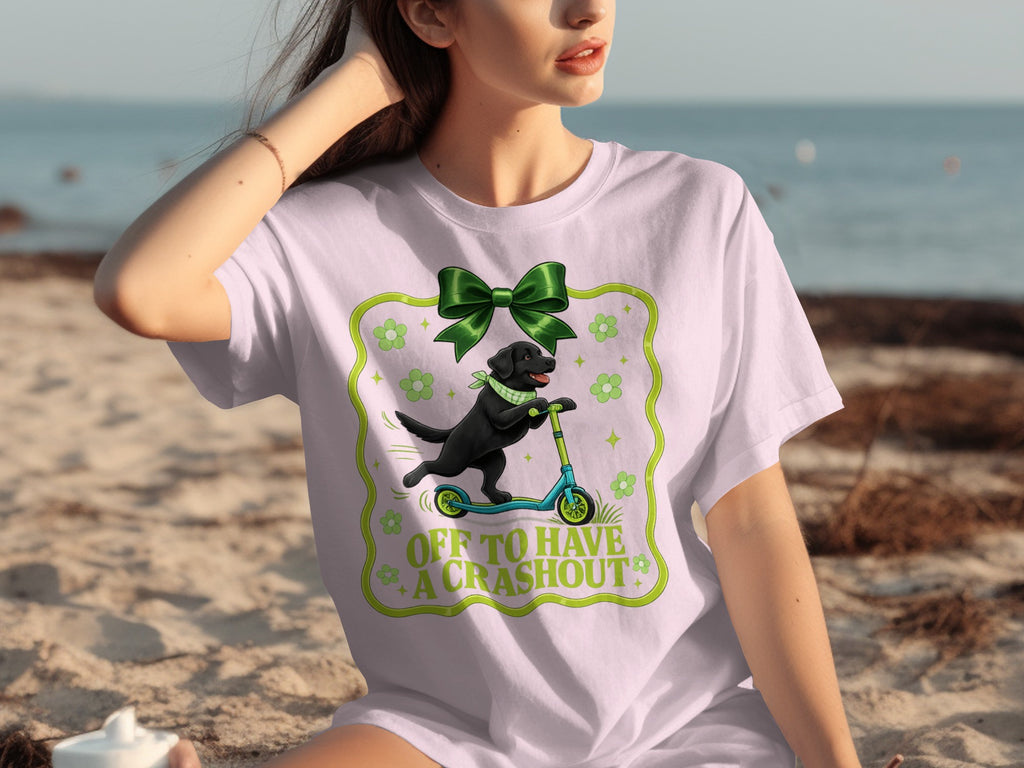 Black Labrador on a scooter with text "OFF TO HAVE A CRASHOUT" on a t-shirt.