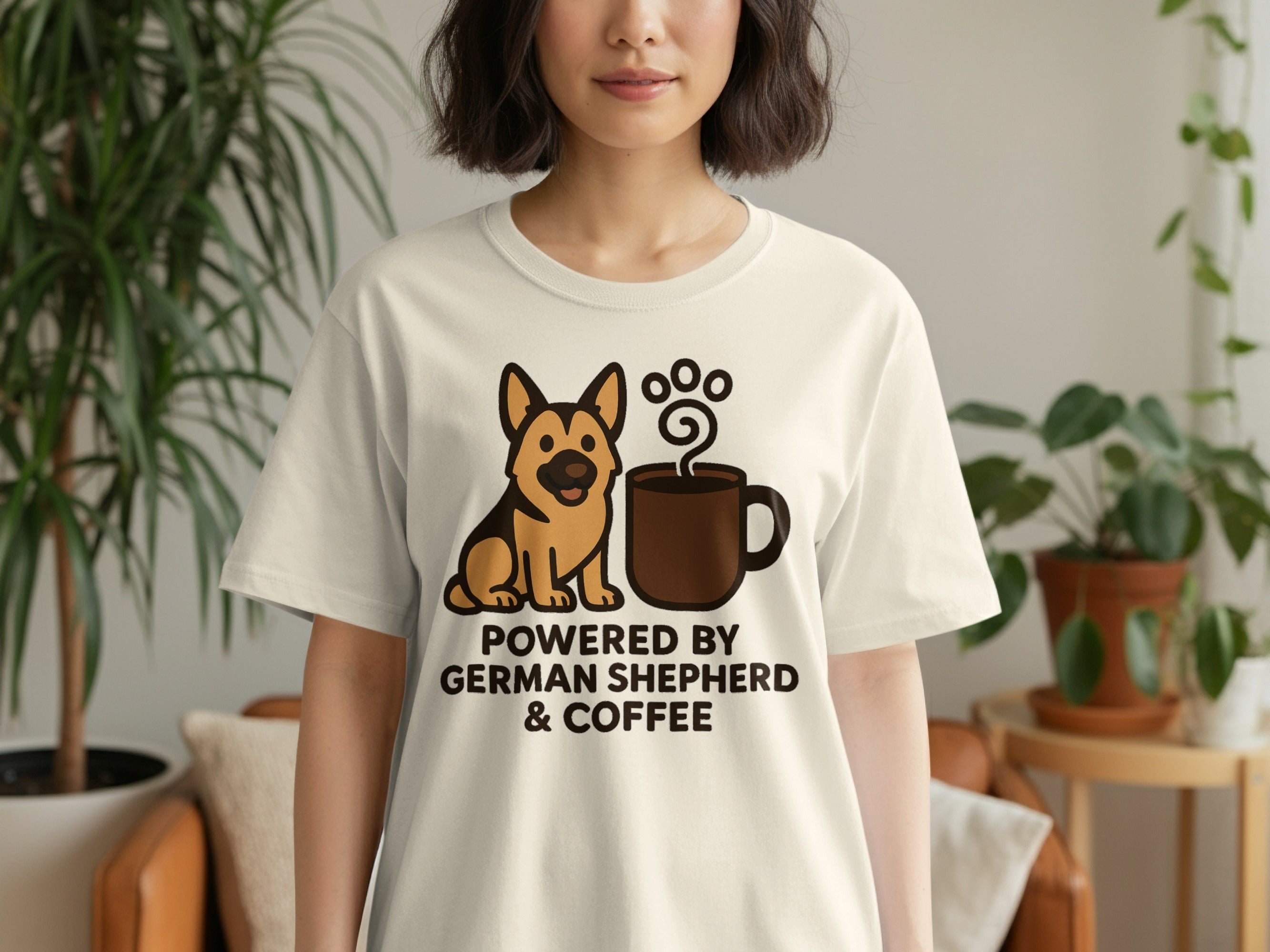 Cream t-shirt with cartoon German Shepherd and coffee mug. Text reads "Powered by German Shepherd & Coffee".
