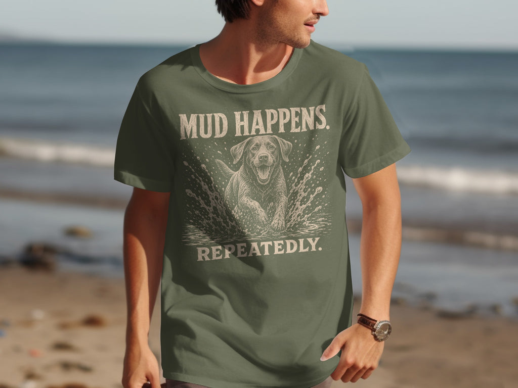 Olive green t-shirt with a dog splashing in water and text "MUD HAPPENS REPEATEDLY".