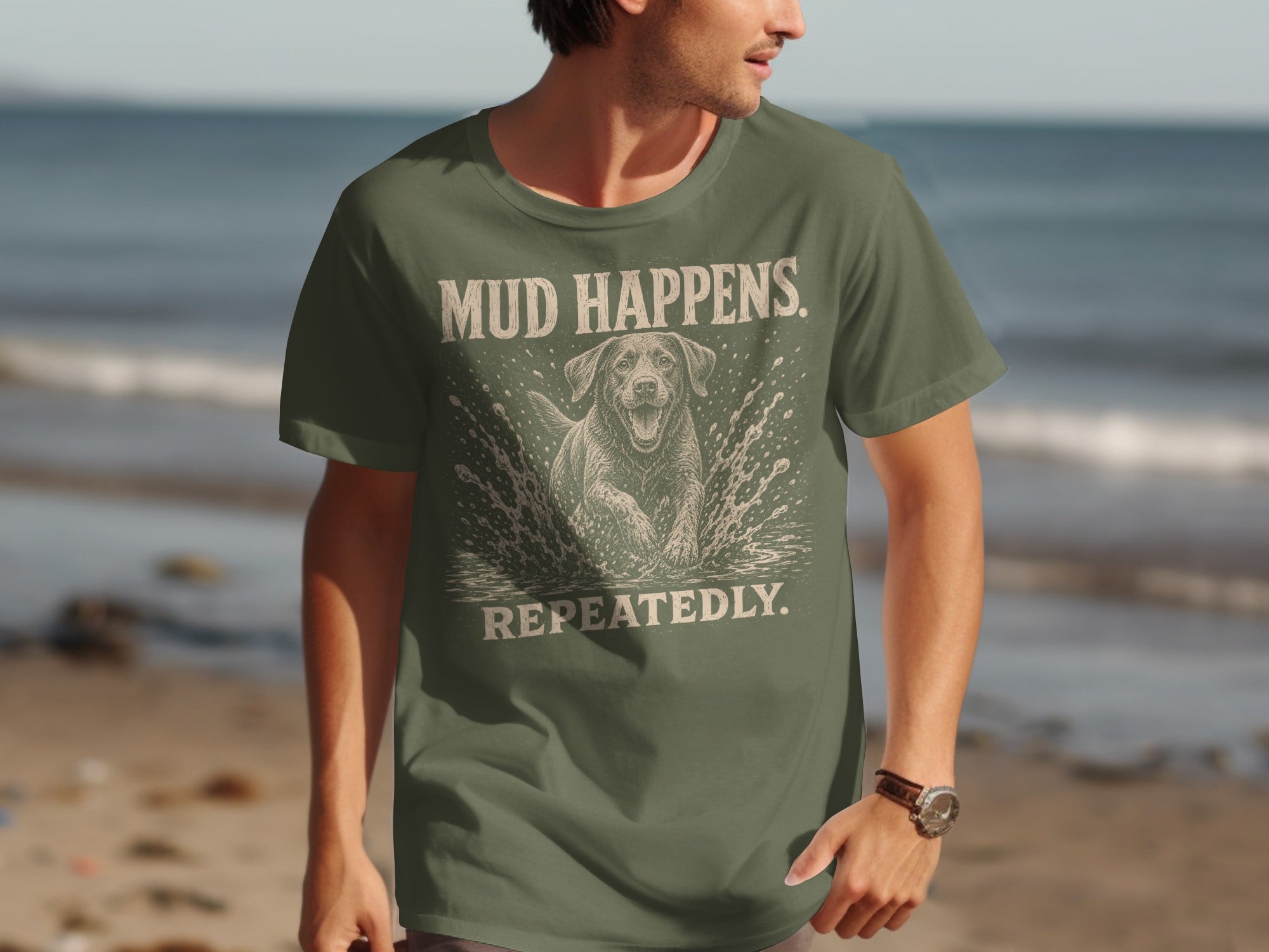 Olive green t-shirt with a dog splashing in water and text "MUD HAPPENS REPEATEDLY".