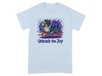 Light blue t-shirt with dog illustration and "Unleash the Joy" text.