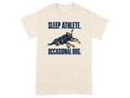 Cream t-shirt with a sleeping dog graphic and text "SLEEP ATHLETE. OCCASIONAL DOG."