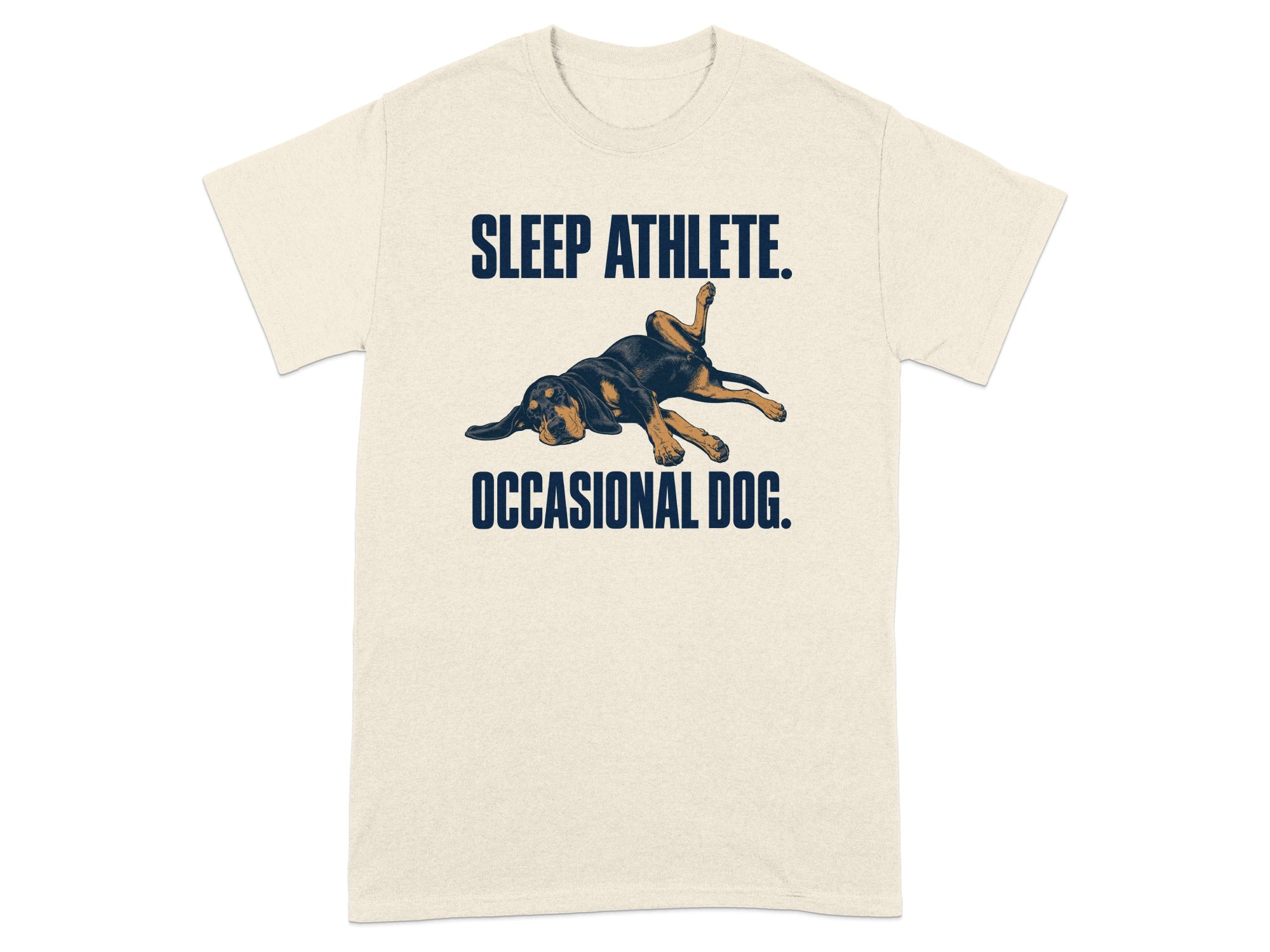 Cream t-shirt with a sleeping dog graphic and text "SLEEP ATHLETE. OCCASIONAL DOG."