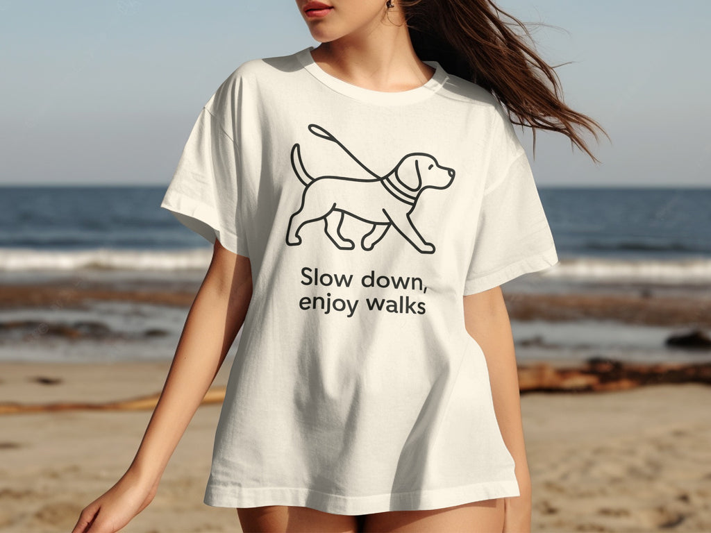White t-shirt with cartoon dog graphic and text "Slow down, enjoy walks".